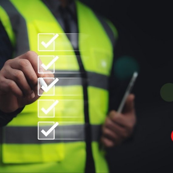 Engineer verifying a digital checklist Engineer verifying a digital checklist